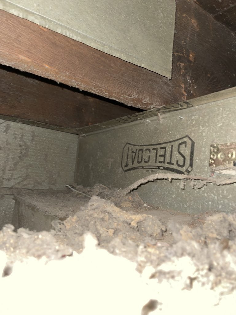 Years of collected debris in an air return duct and joist space