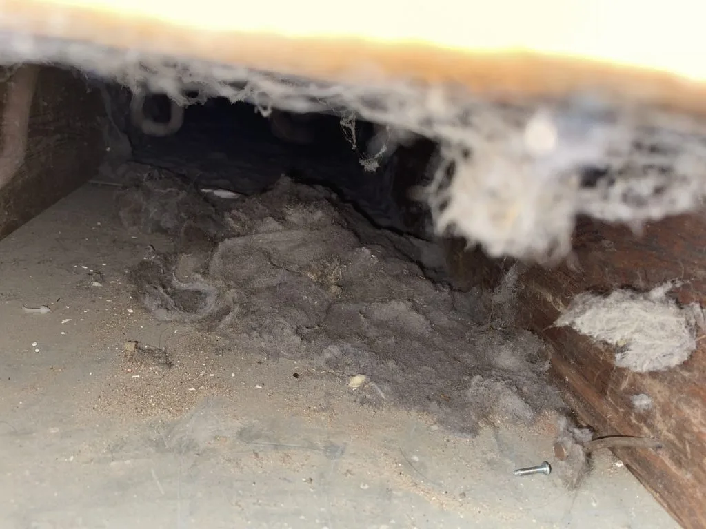 Close-up of a dusty duct seam and joint with heavy grime