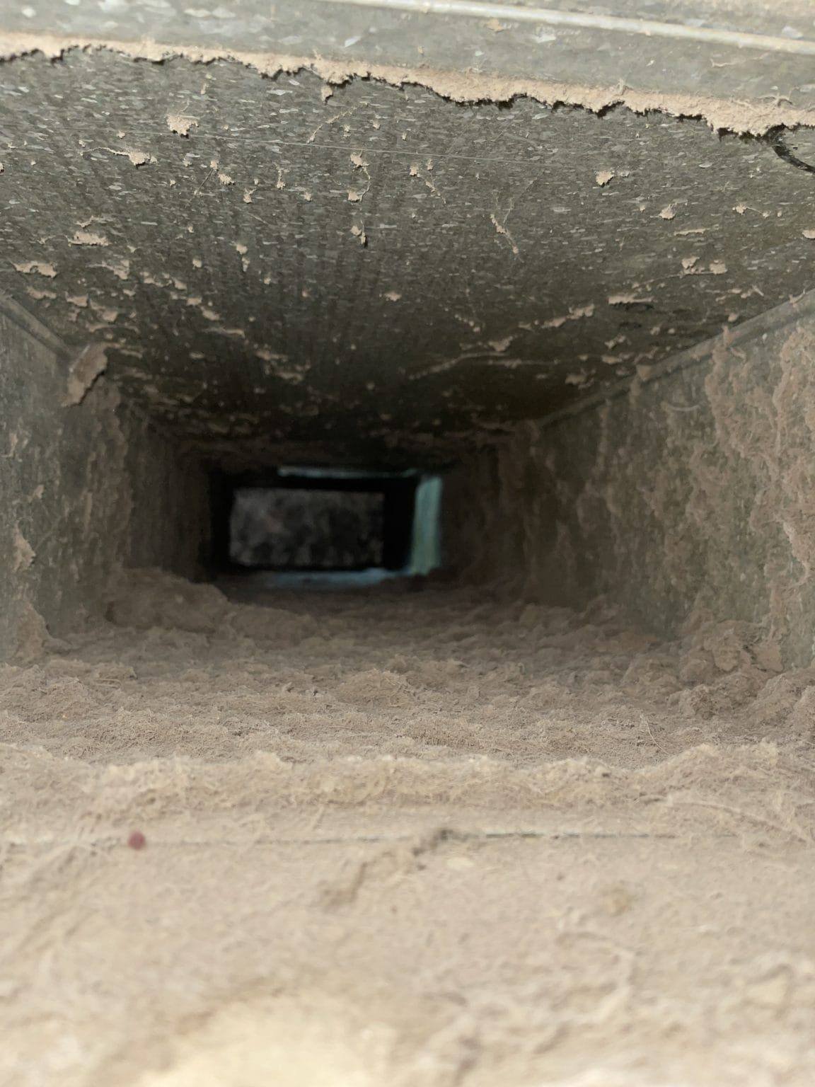 Duct interior before cleaning in a Toronto home, heavy dust buildup